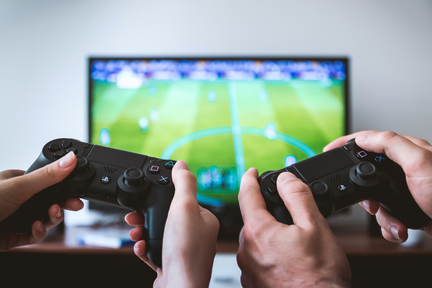 people holding controllers playing games